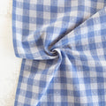 close up or blue and white gingham fabric with textured heart pattern