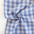 close up or blue and white gingham fabric with textured heart pattern
