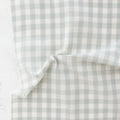 close up of white and light green/grey gingham fabric from the brand "fableism"