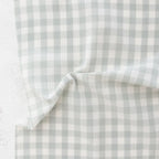 close up of white and light green/grey gingham fabric from the brand "fableism"