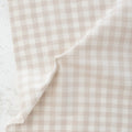 Close of of beige and white gingham fabric from the brand "fableism"