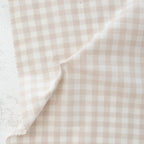 Close of of beige and white gingham fabric from the brand "fableism"
