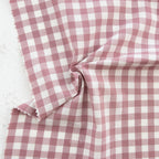 close up of white and mauve gingham fabric from the brand "fableism"
